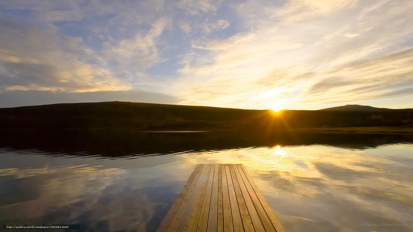 Sunset over a lake with a dock