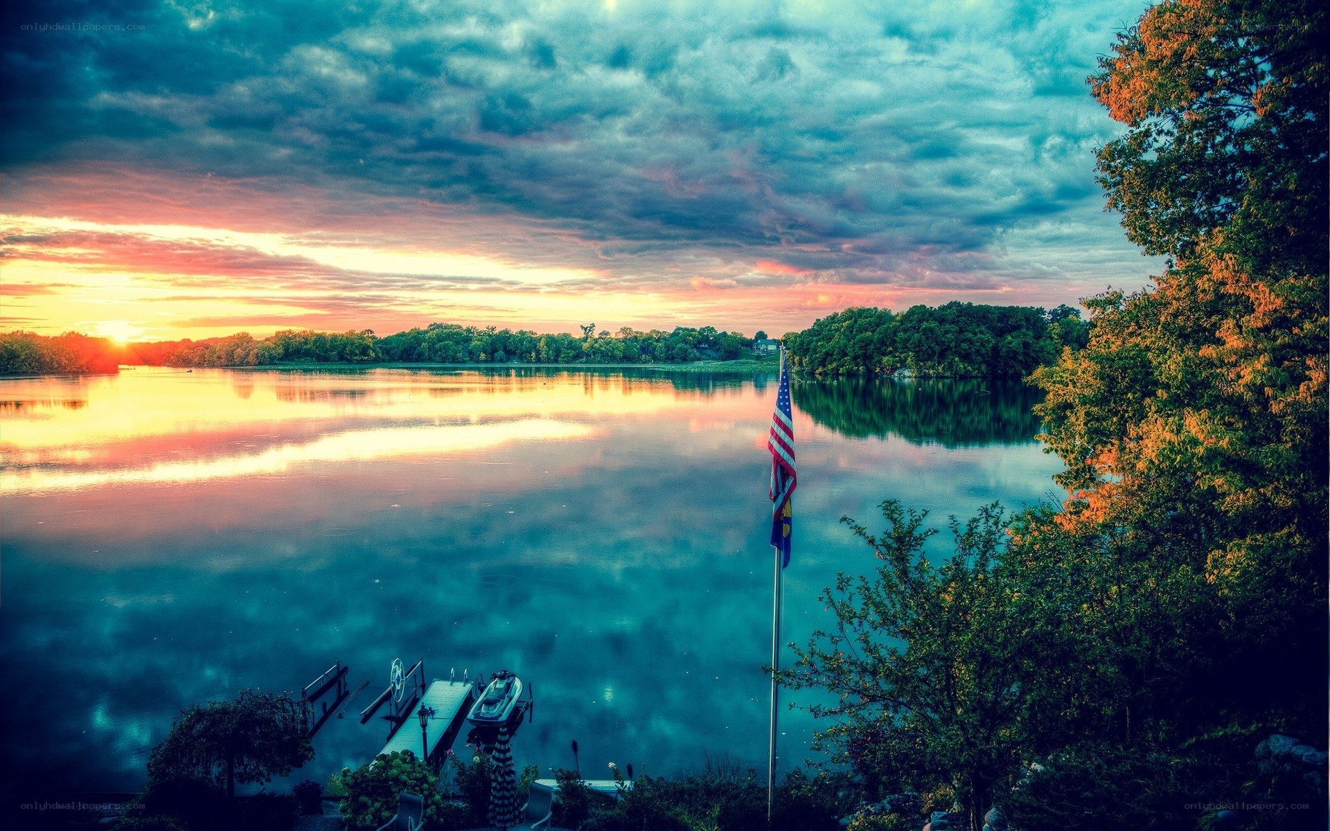 Sunset over a lake with American flag