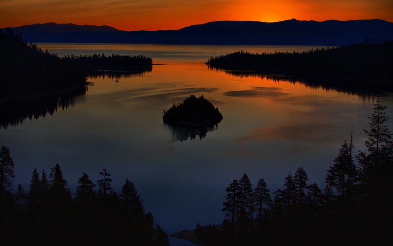 Sunset over a lake with an island