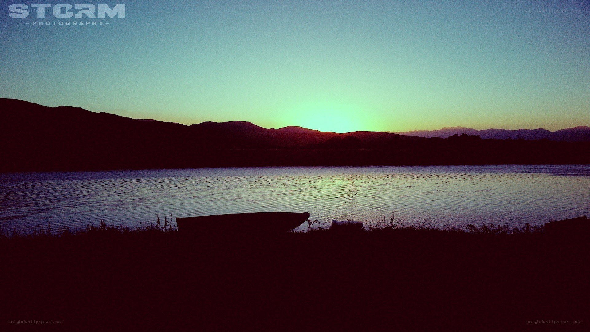 Sunset over a lake with boat