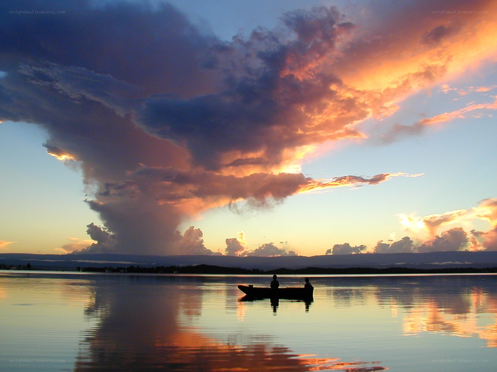 Sunset over a lake with boat