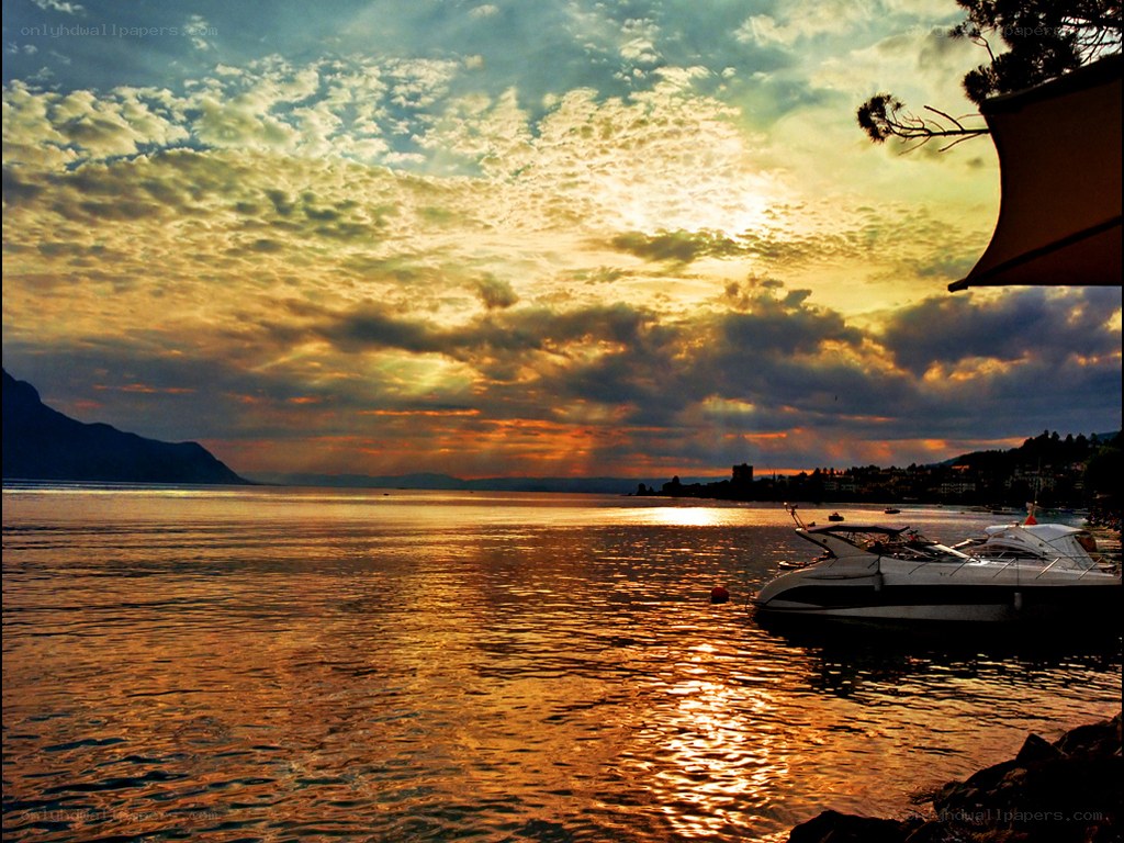 Sunset over a lake with boats