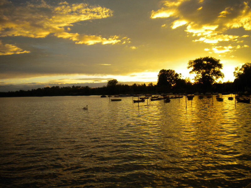 Sunset over a lake with boats