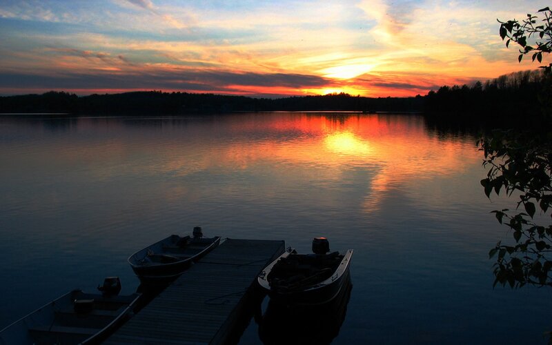 Sunset over a lake with boats
