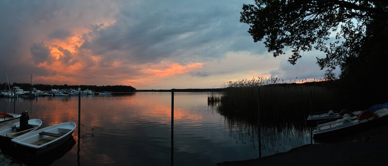 sunset over a lake with boats