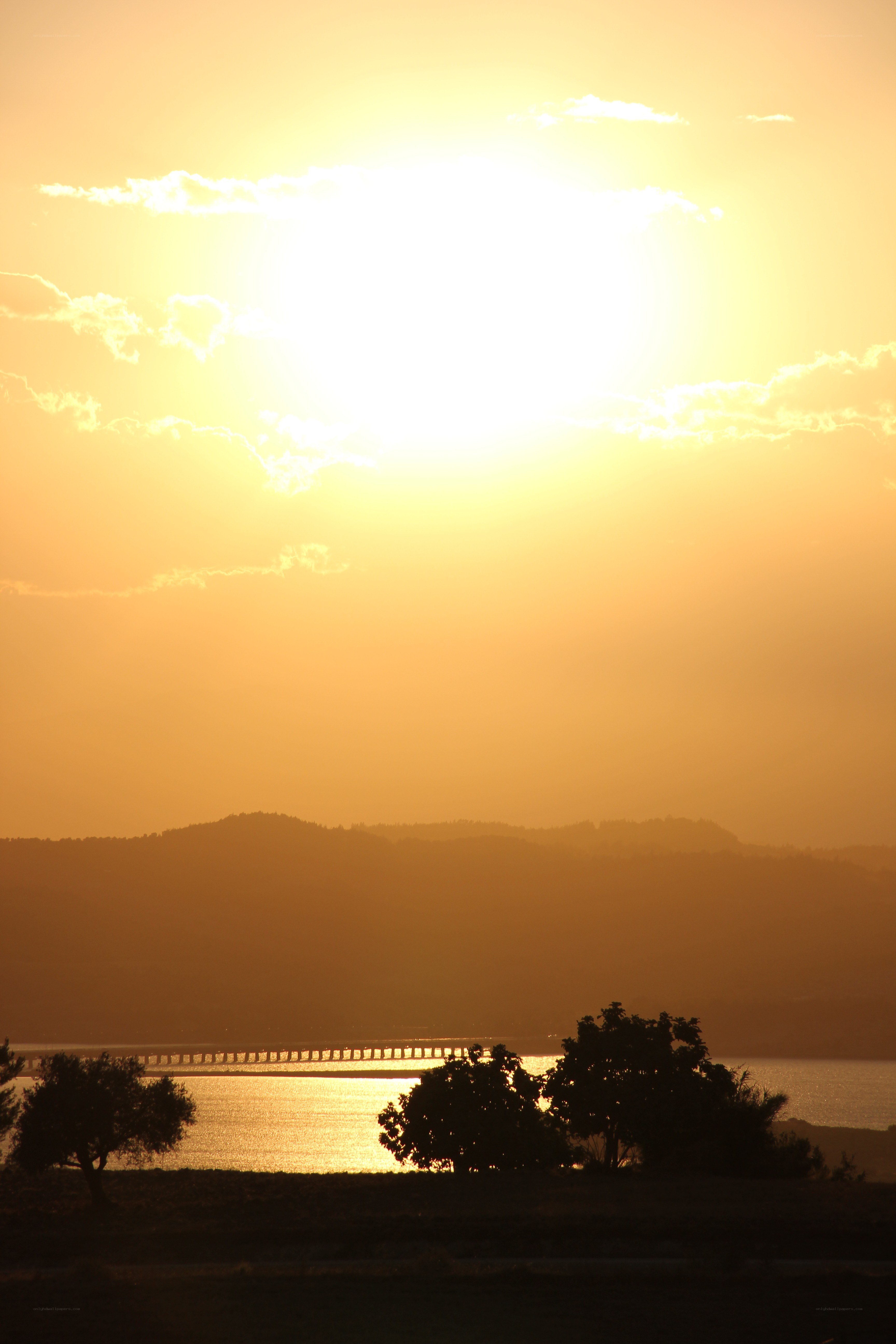 Sunset over a lake with bridge