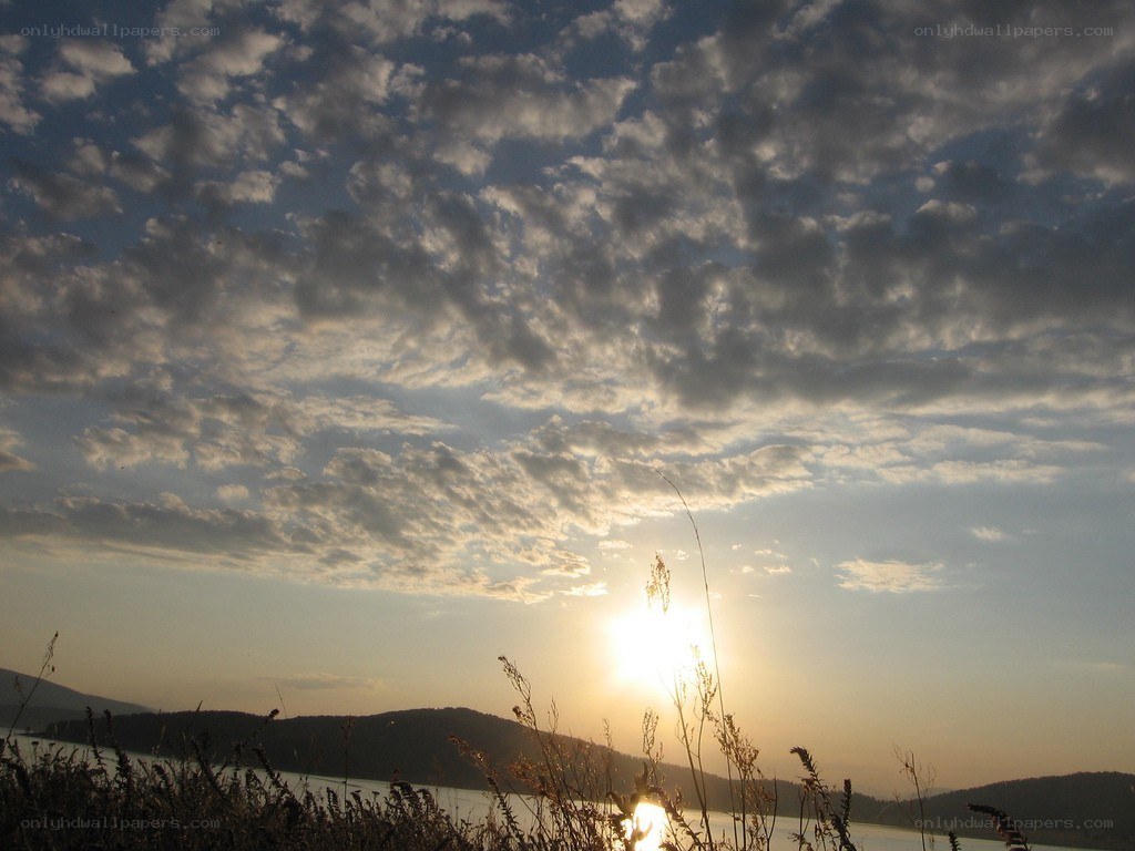 Sunset over a lake with clouds