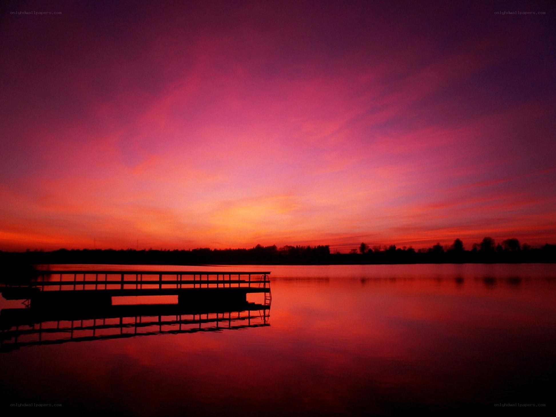 sunset over a lake with dock