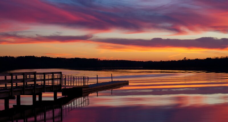 sunset over a lake with dock
