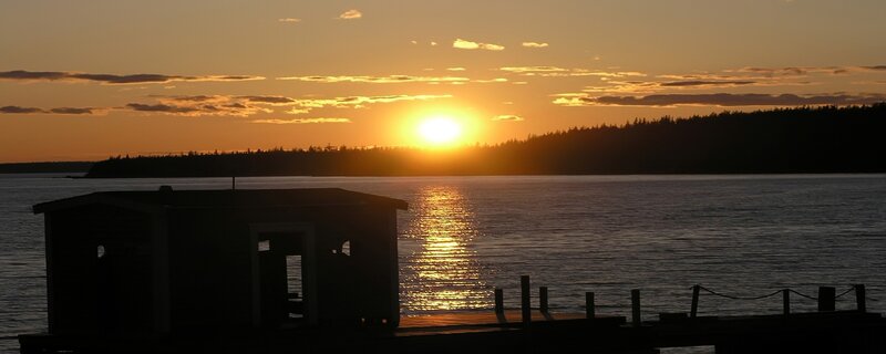 sunset over a lake with dock