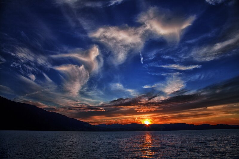 Sunset over a lake with dramatic clouds