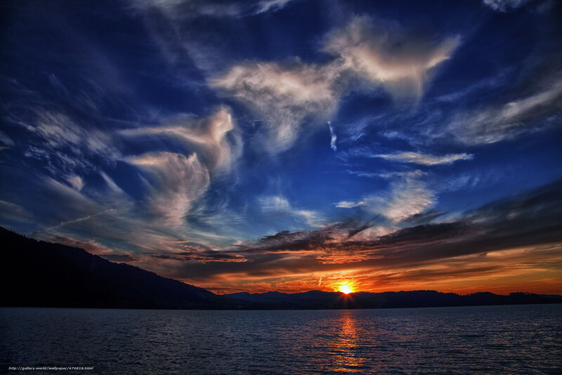 Sunset over a lake with dramatic clouds