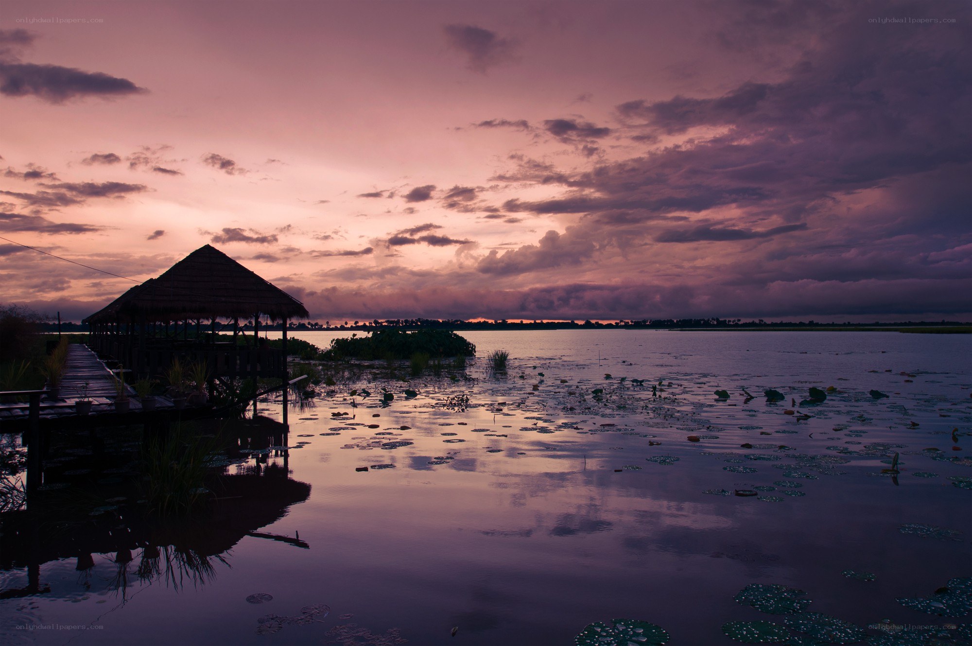 Sunset over a lake with gazebo