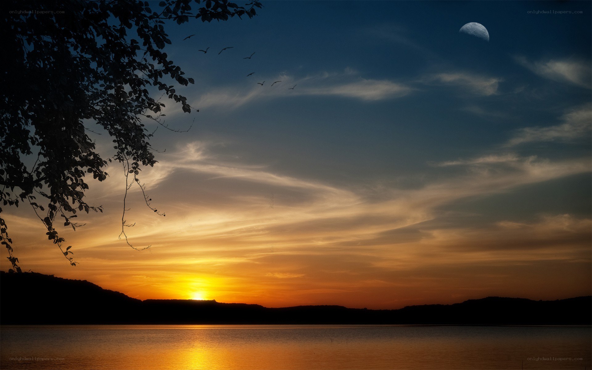 Sunset over a lake with moon