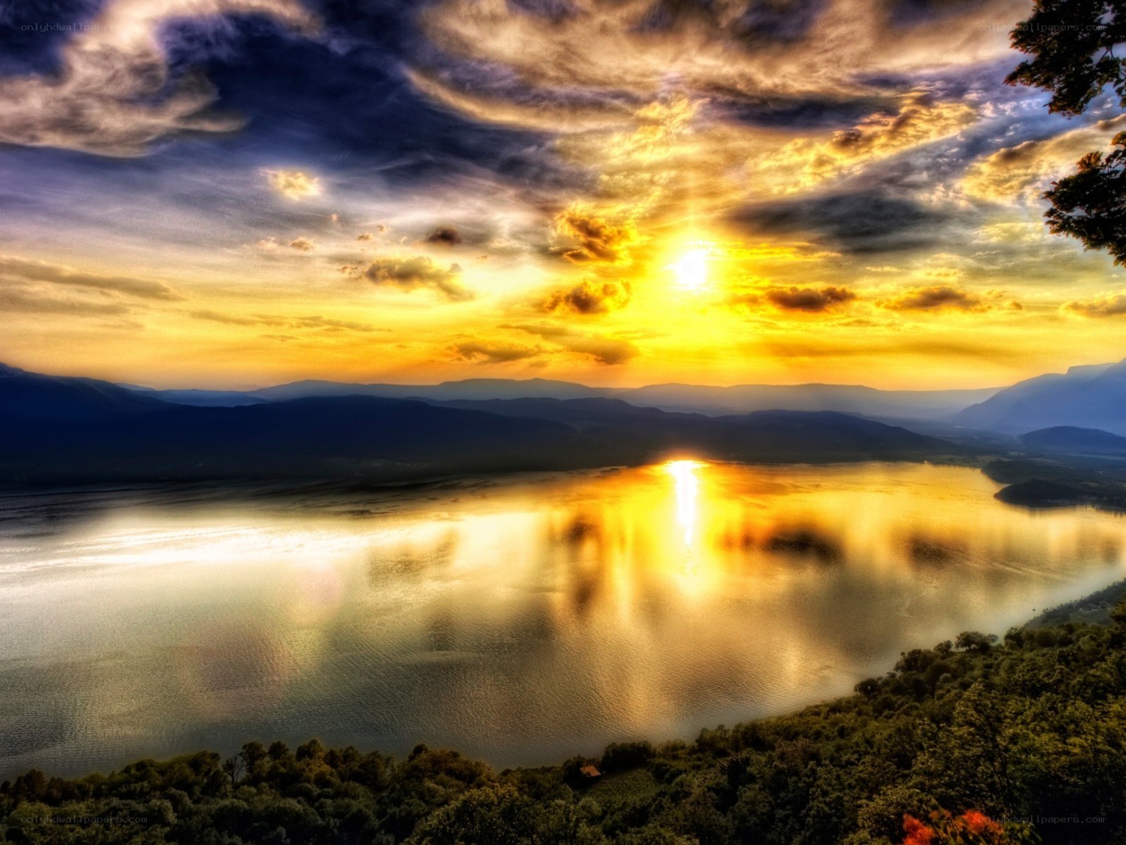 Sunset over a lake with mountains