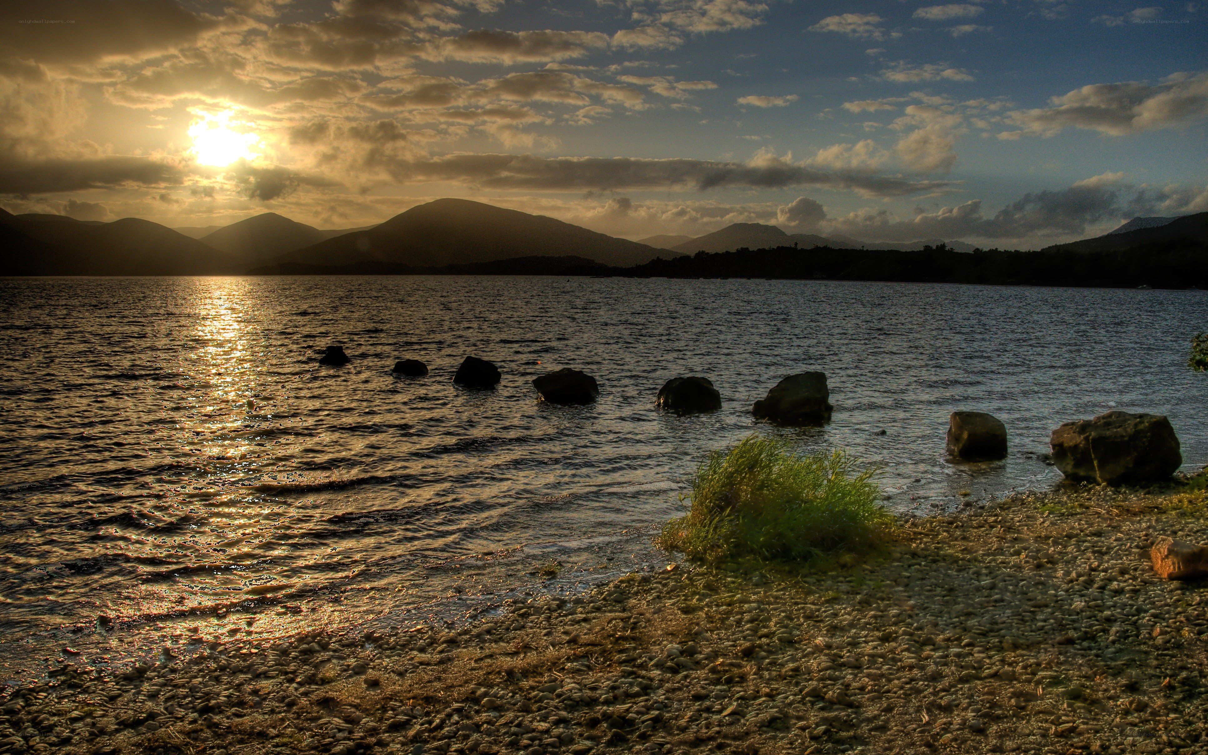 Sunset over a lake with mountains