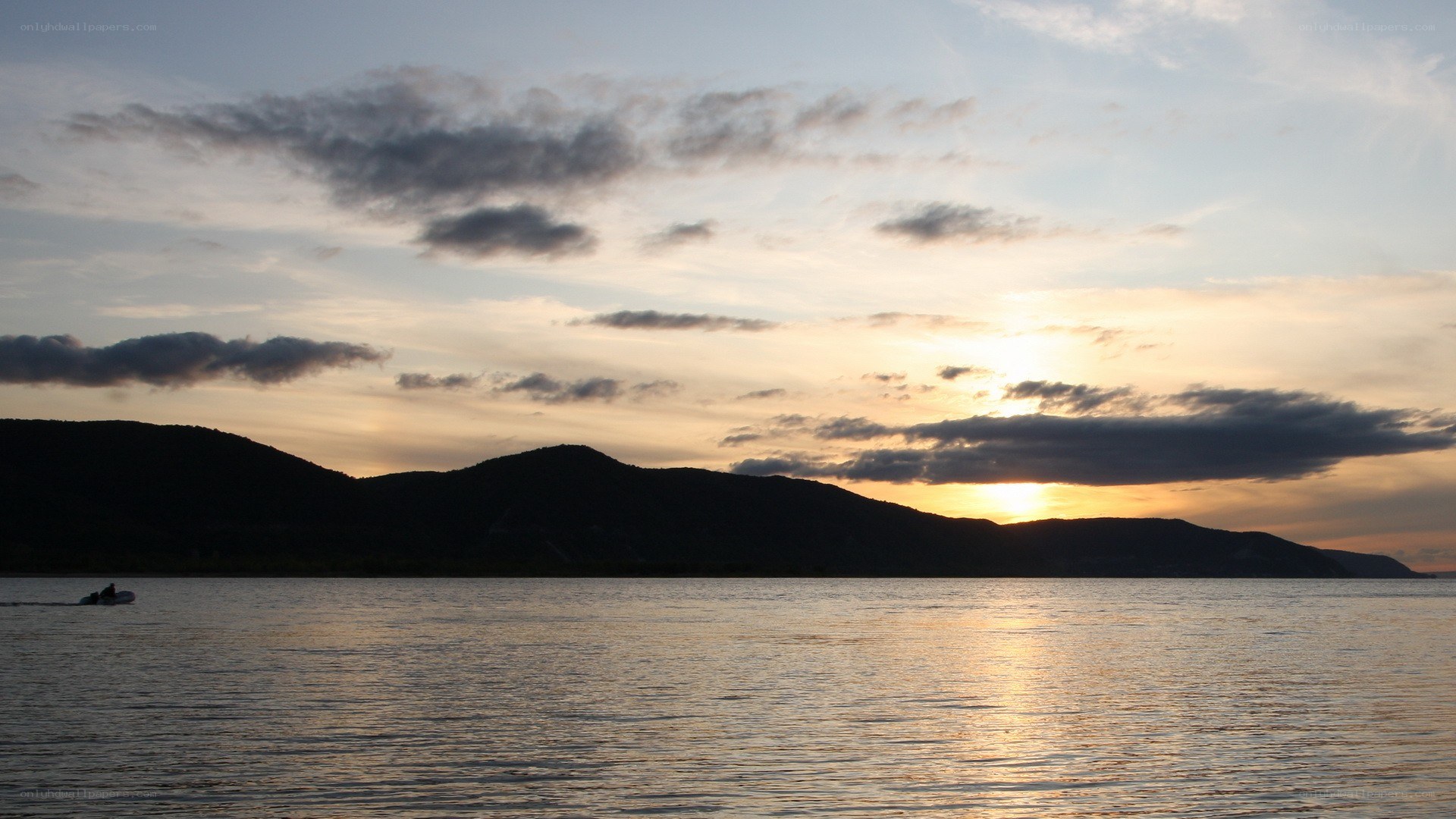 Sunset over a lake with mountains