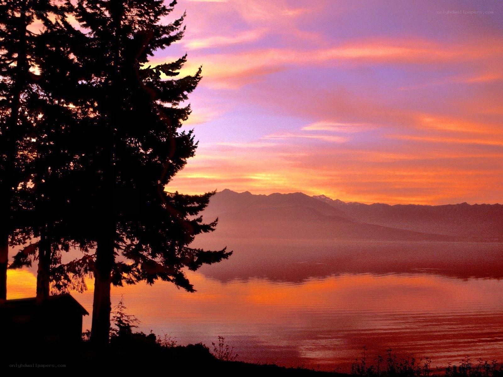 Sunset over a lake with mountains