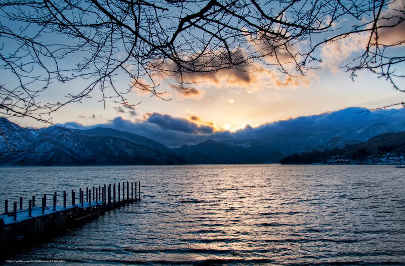 Sunset over a lake with mountains