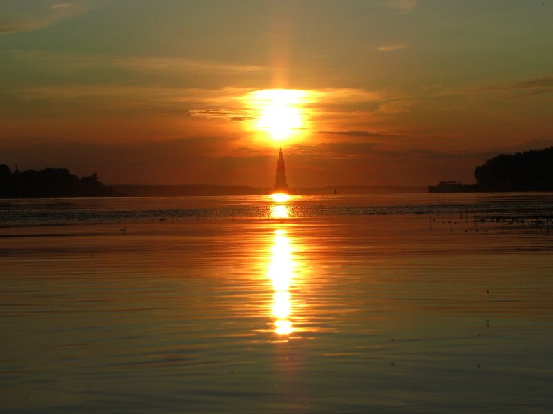 Sunset over a lake with tower