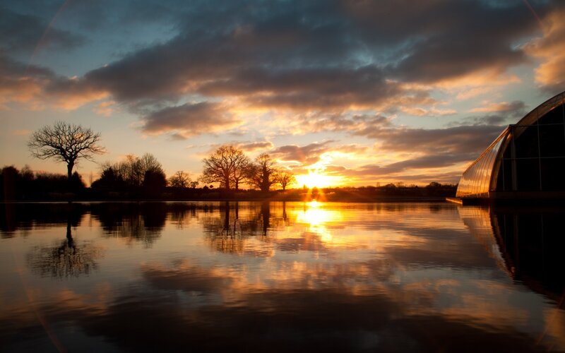 Sunset over a lake with trees