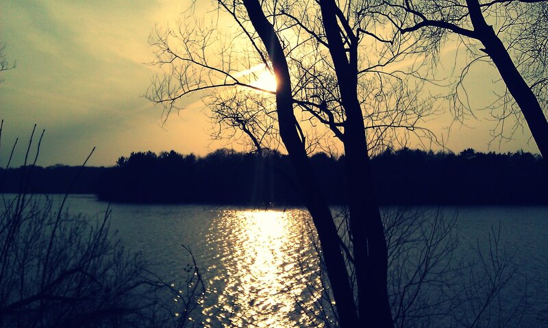 Sunset over a lake with trees