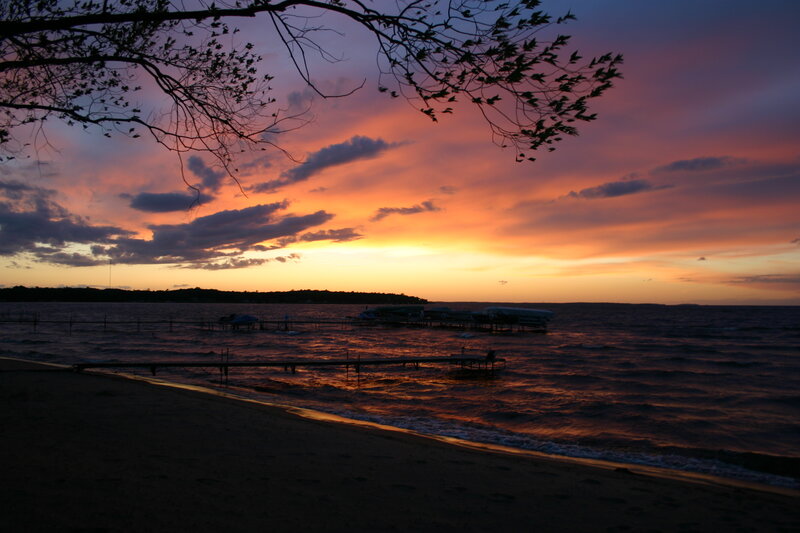sunset over a lakeside beach