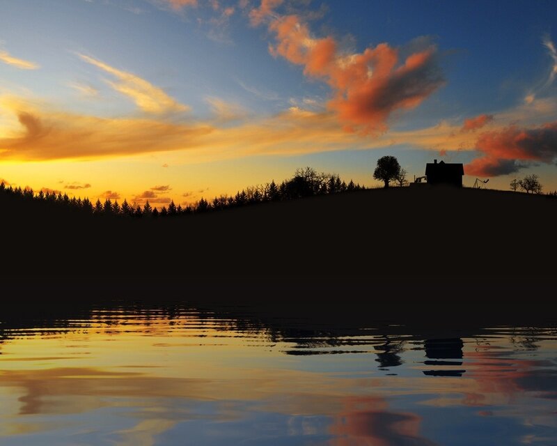 sunset over a lakeside house