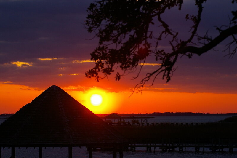 Sunset over a lakeside pavilion