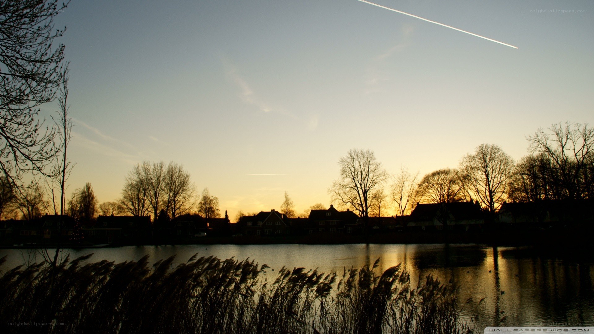 sunset over a lakeside village