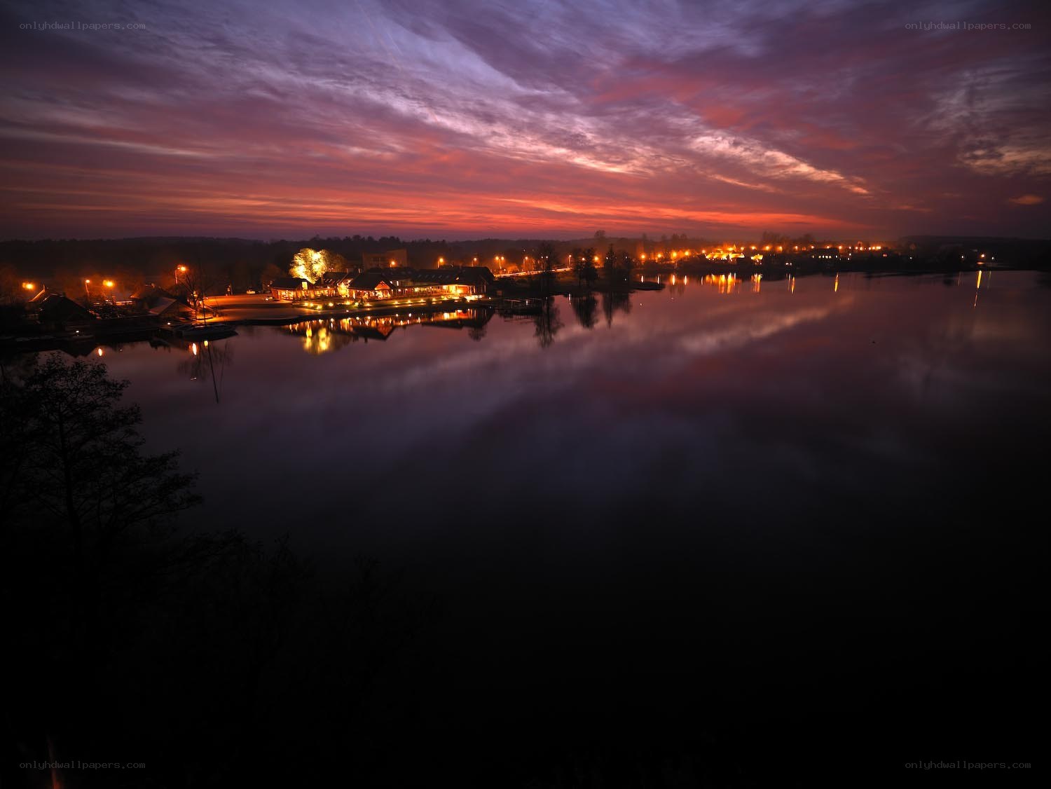 sunset over a lakeside village