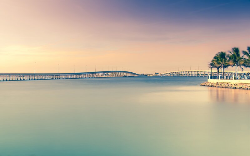 Sunset over a long bridge