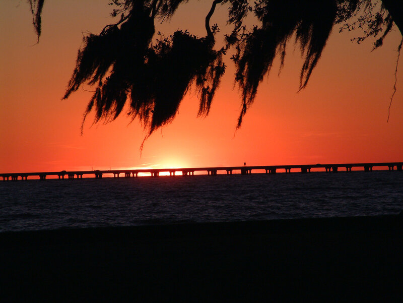 sunset over a long bridge