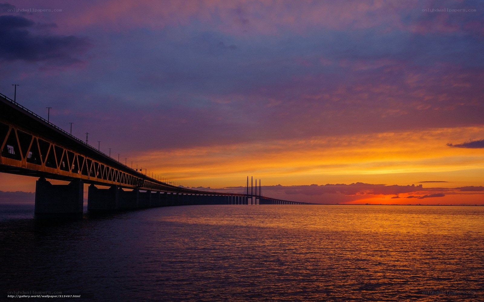 Sunset over a long bridge