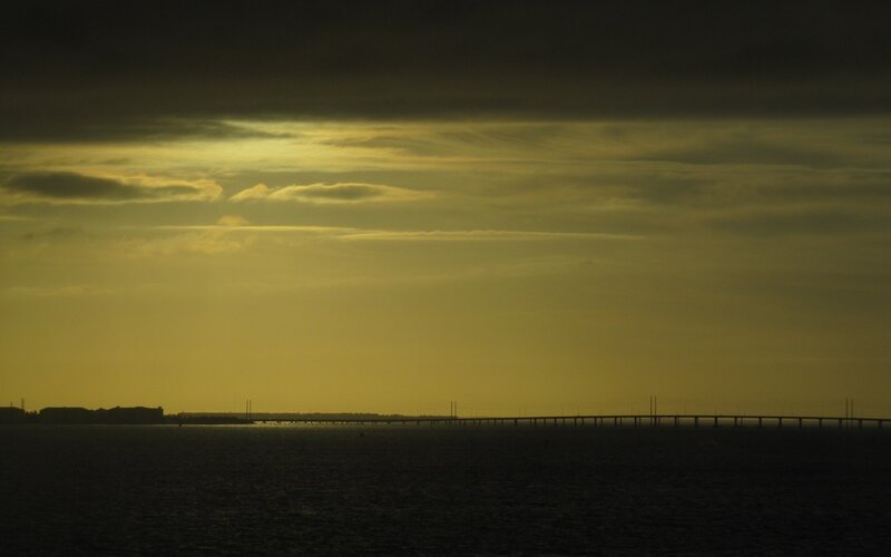 Sunset over a long bridge
