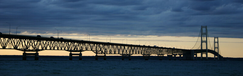 sunset over a long bridge