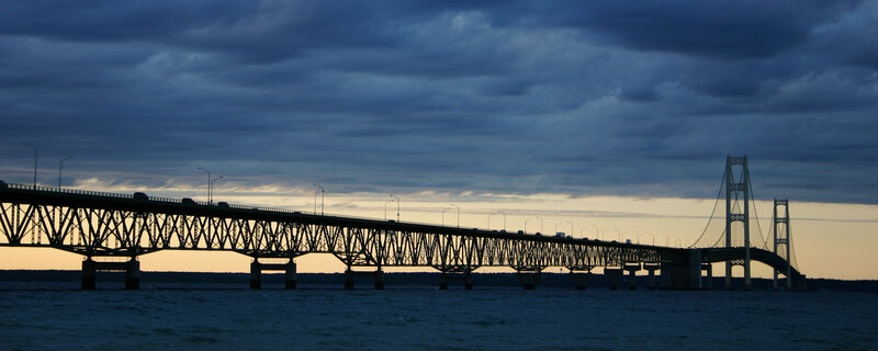 sunset over a long bridge