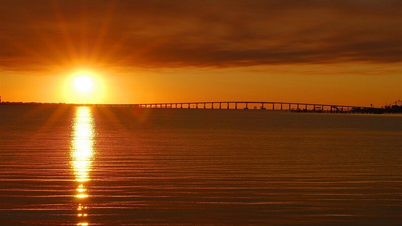 Sunset over a long bridge