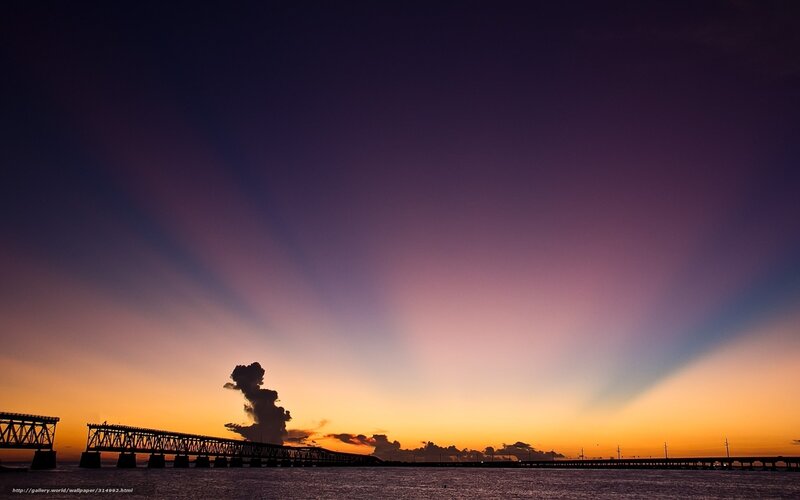 Sunset over a long bridge