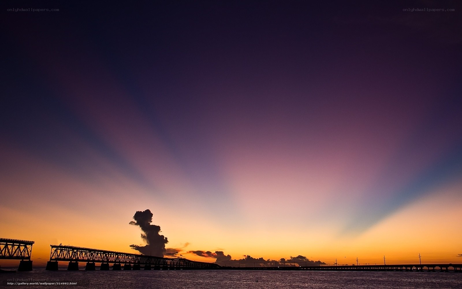 Sunset over a long bridge