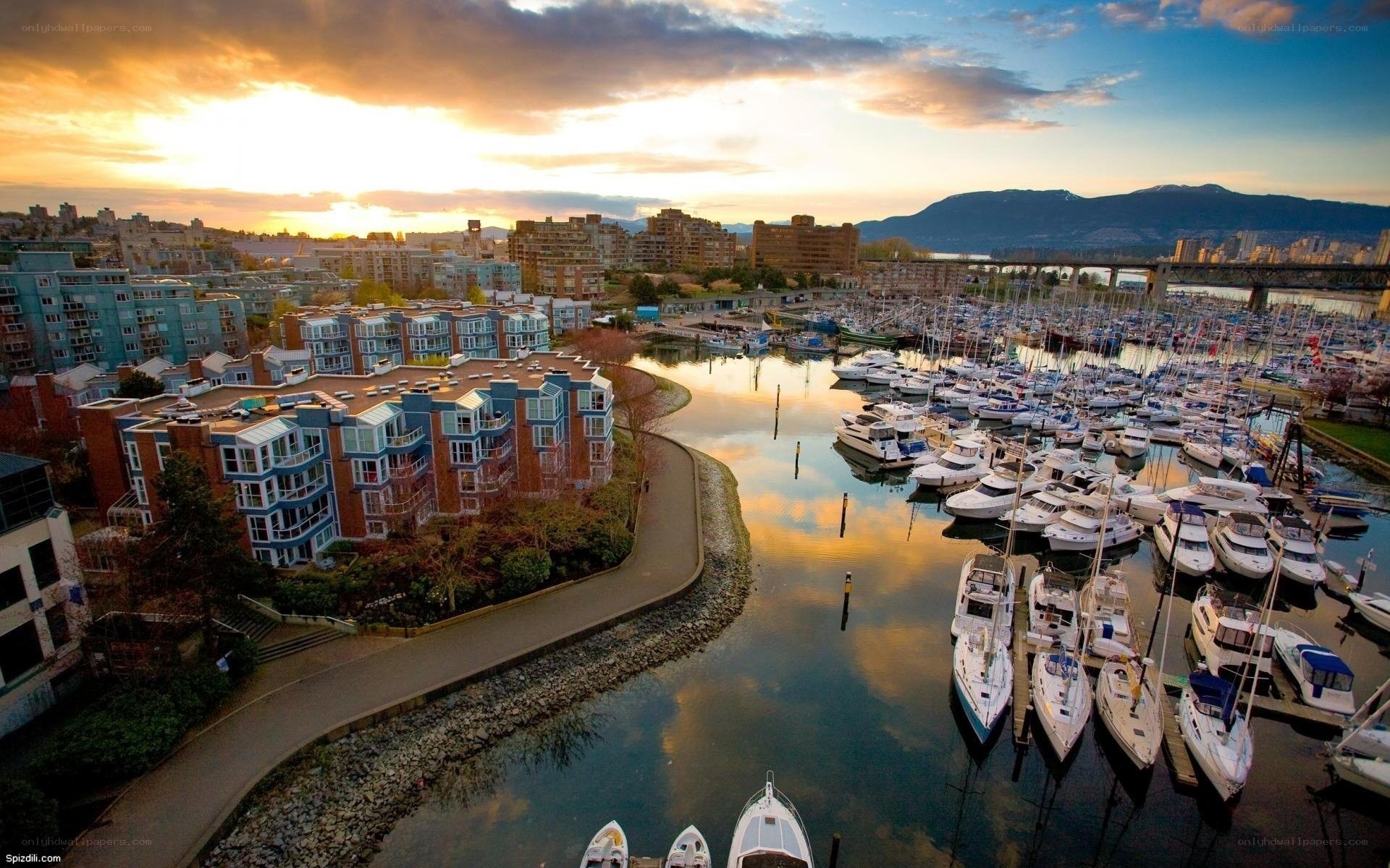 Sunset over a marina and city