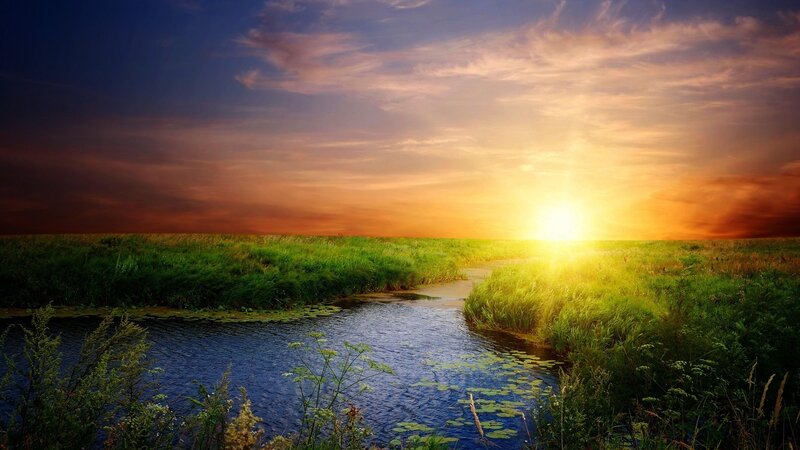 Sunset over a meadow stream