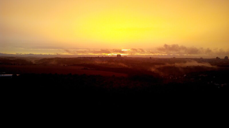 sunset over a misty city