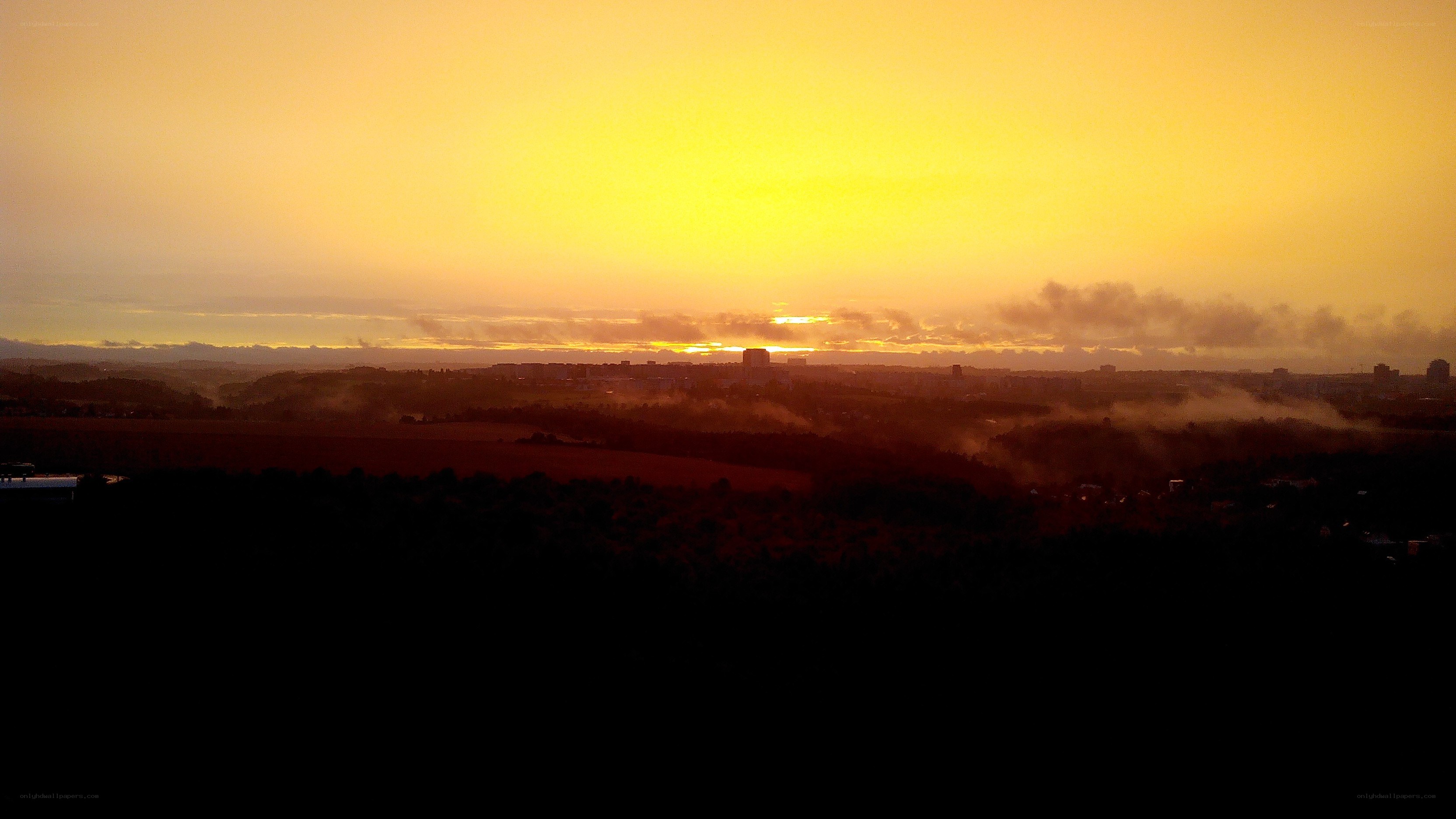 sunset over a misty city