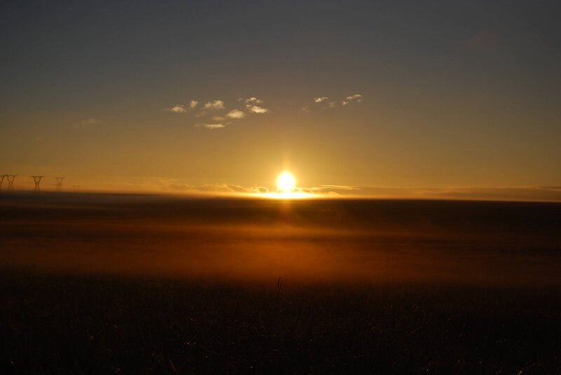 Sunset over a misty field