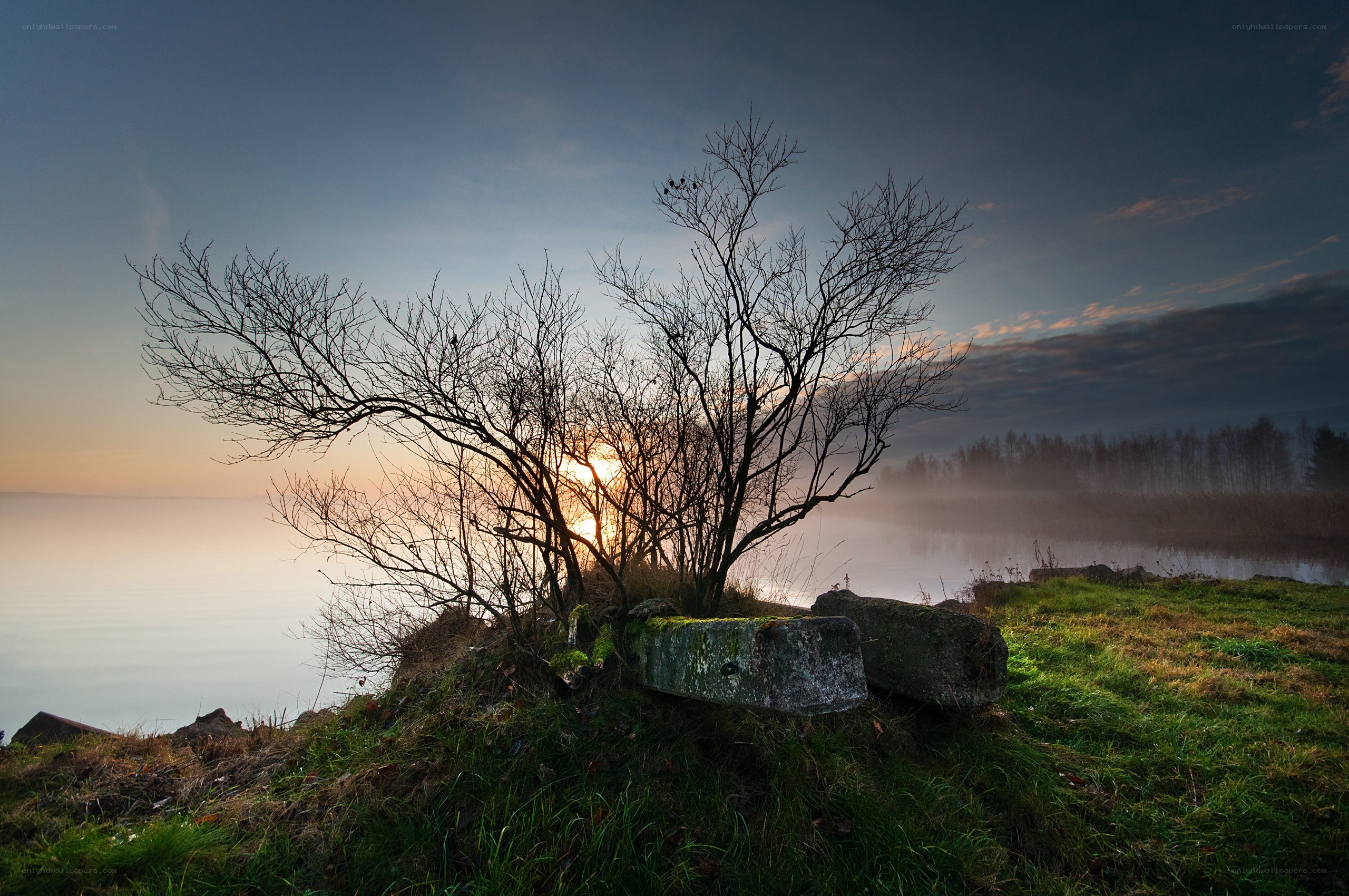 Sunset over a misty lake