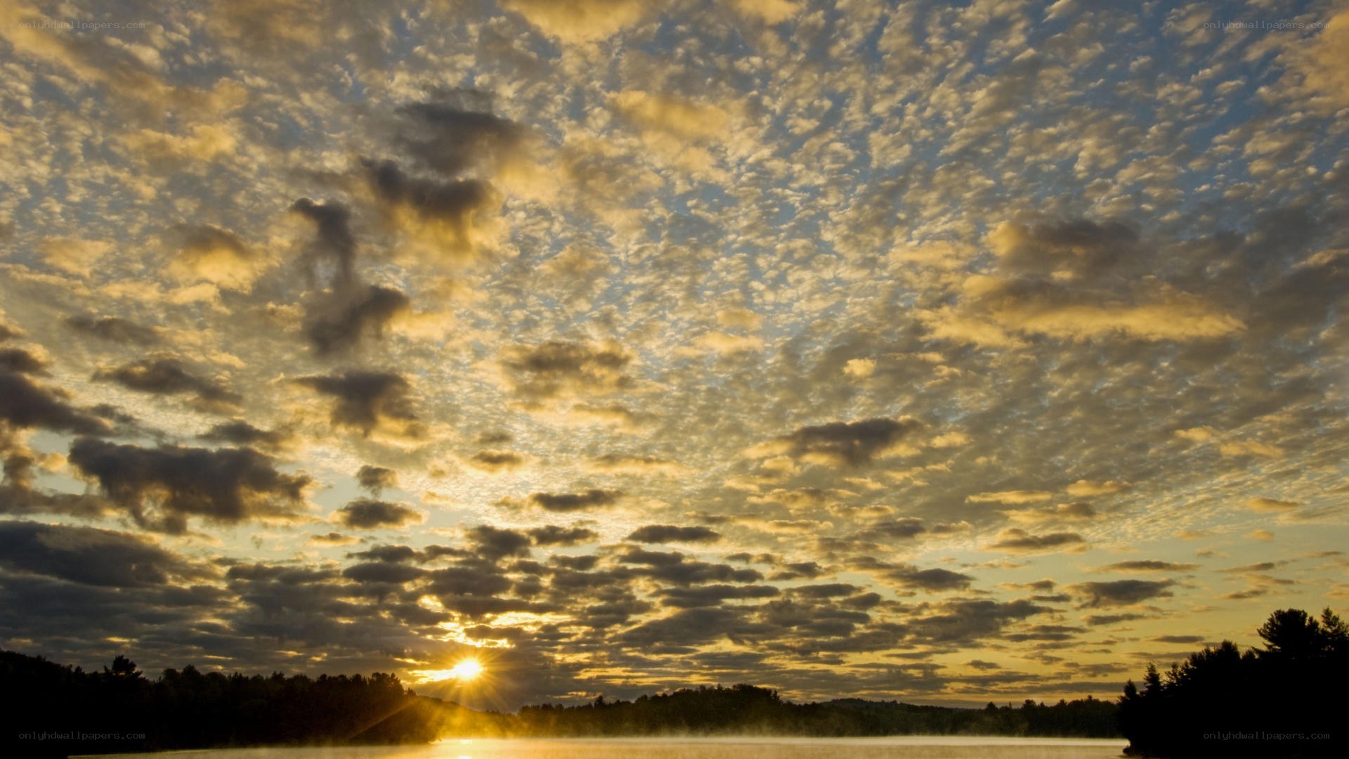 Sunset over a misty lake
