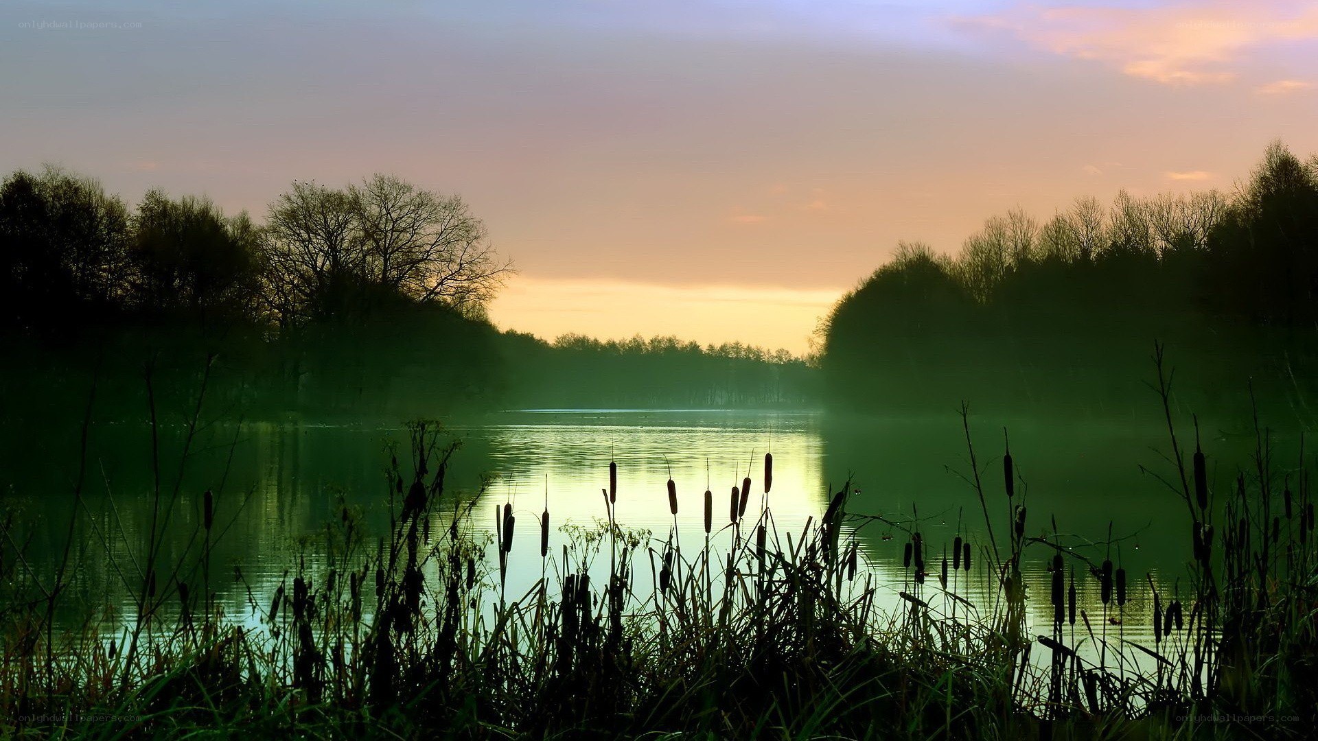 Sunset over a misty lake