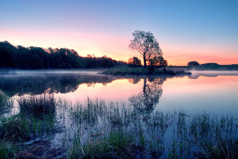 Sunset over a misty lake
