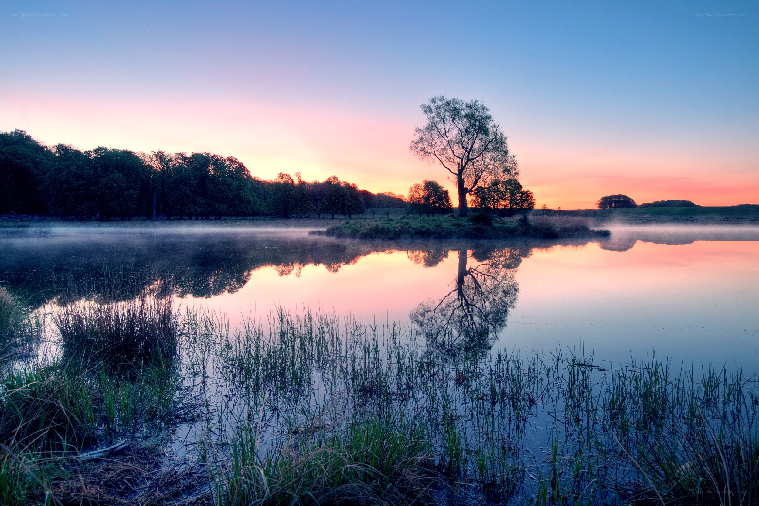 Sunset over a misty lake